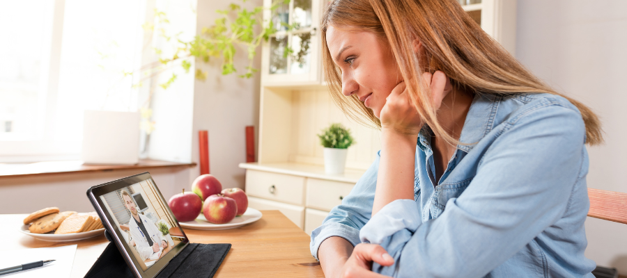 Woman at home having a video call with doctor through tablet