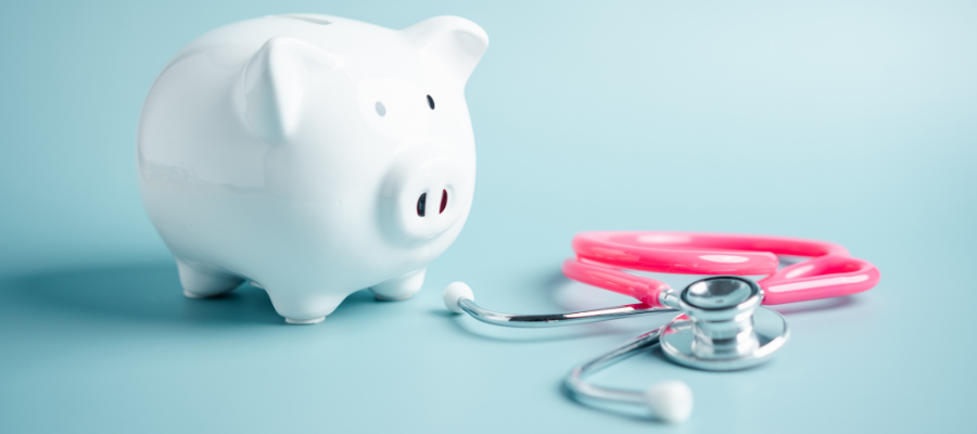 Piggy bank and pink stethoscope 